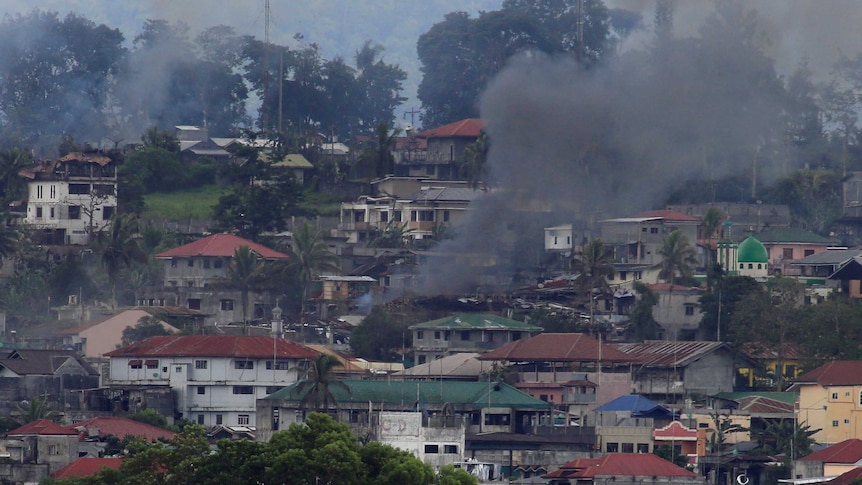 Smokes rises above besieged Marawi City in the distance