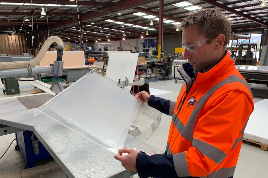 PFG Group chief executive Robert Inches with an acrylic screen produced by Plastic Fabrications.
