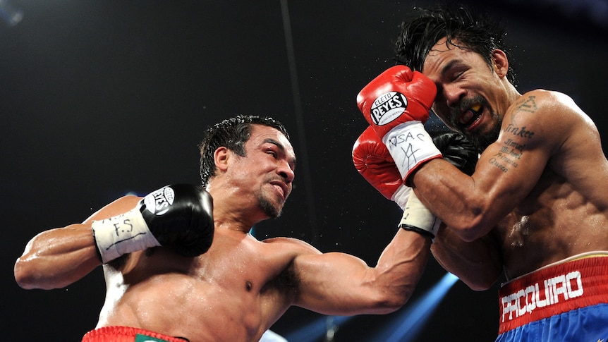 Juan Manual Marquez throws a punch at Manny Pacquiao during third fight in Las Vegas