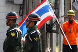 Thai anti-government protester looks at military