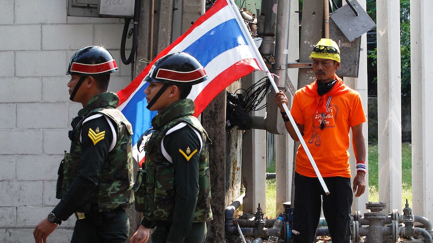 Thai anti-government protester looks at military