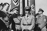 Hiitler stands with Nazi commanders