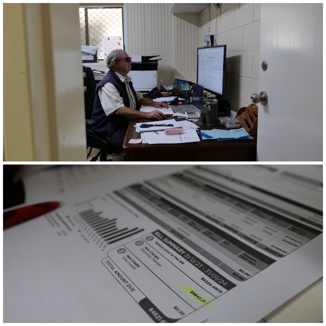 A man at his desk and a copy of his power bills.