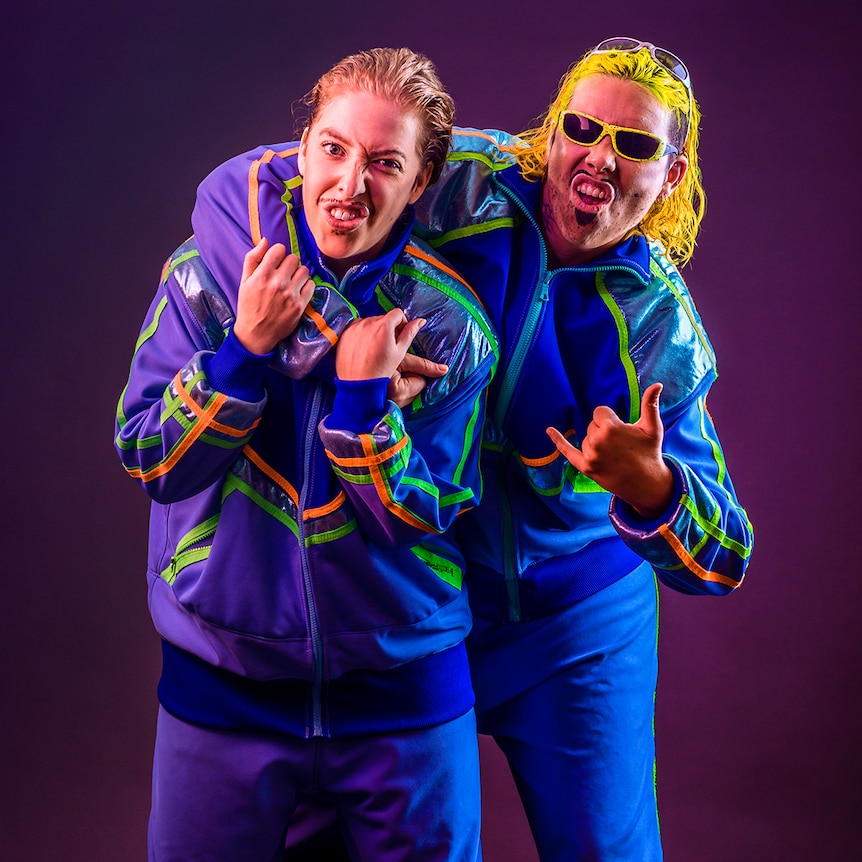 Drag characters Dazza and Keif pose in matching tracksuits.