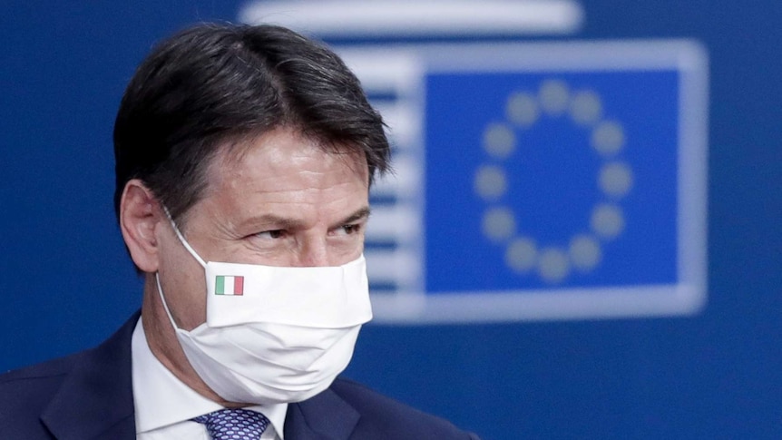 Italy's Prime Minister Giuseppe Conte wears a face mask with the Italian flag printed on.