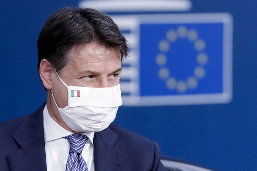 Italy's Prime Minister Giuseppe Conte wears a face mask with the Italian flag printed on.