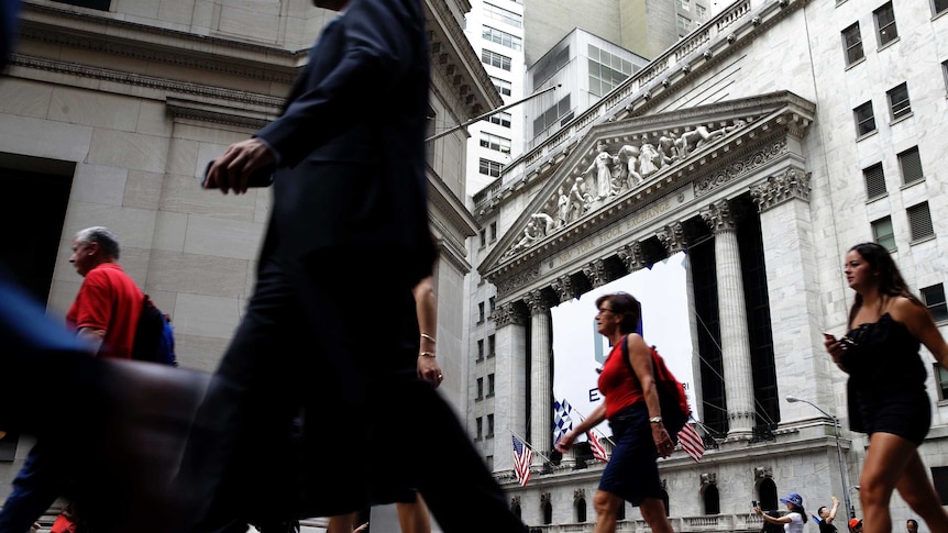 People walking past the New York Stock Exchange.