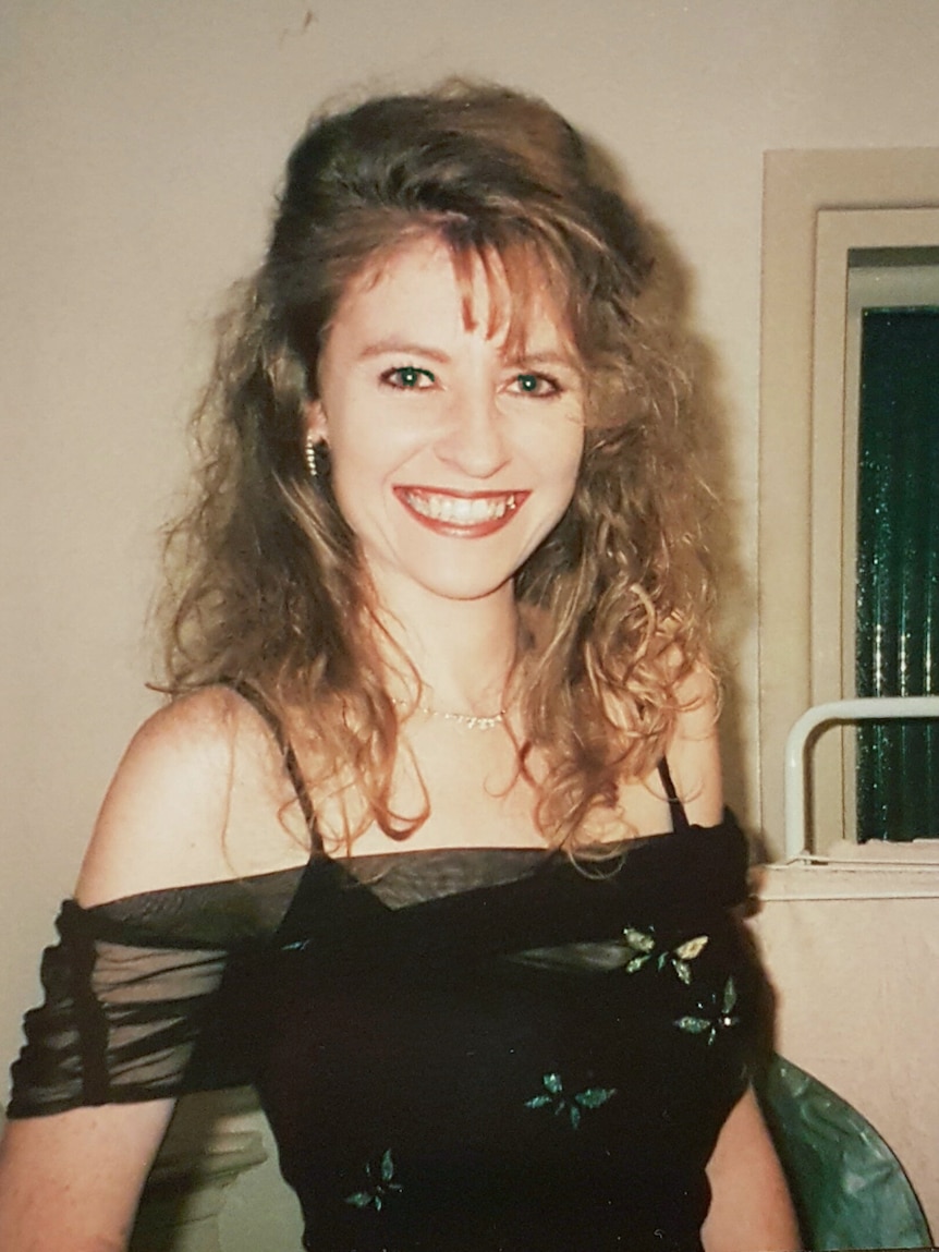 Janine Vaughan smiling and wearing a dress