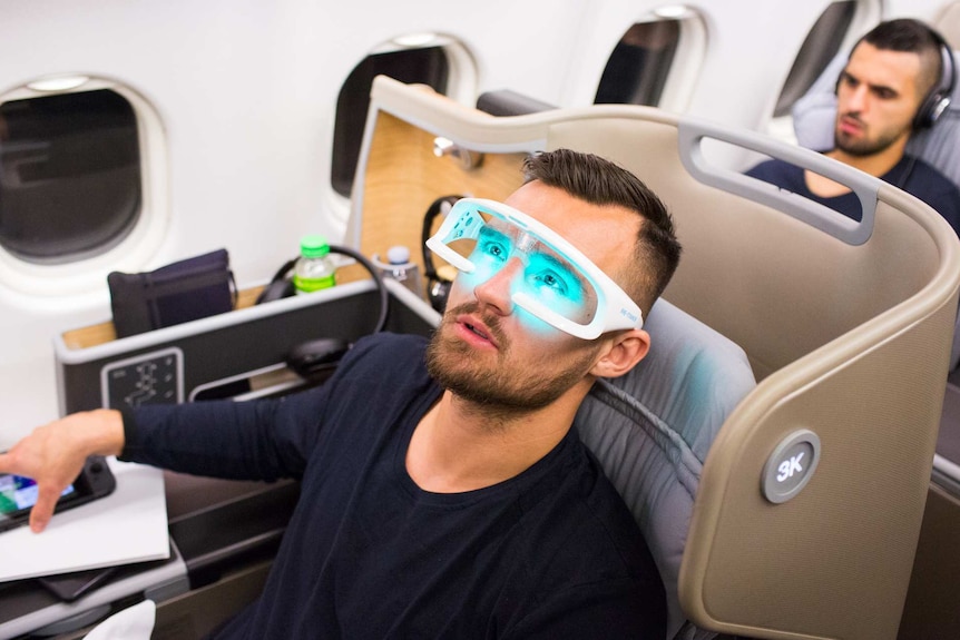 Bailey Wright wearing anti-fatigue glasses on Socceroos charter flight