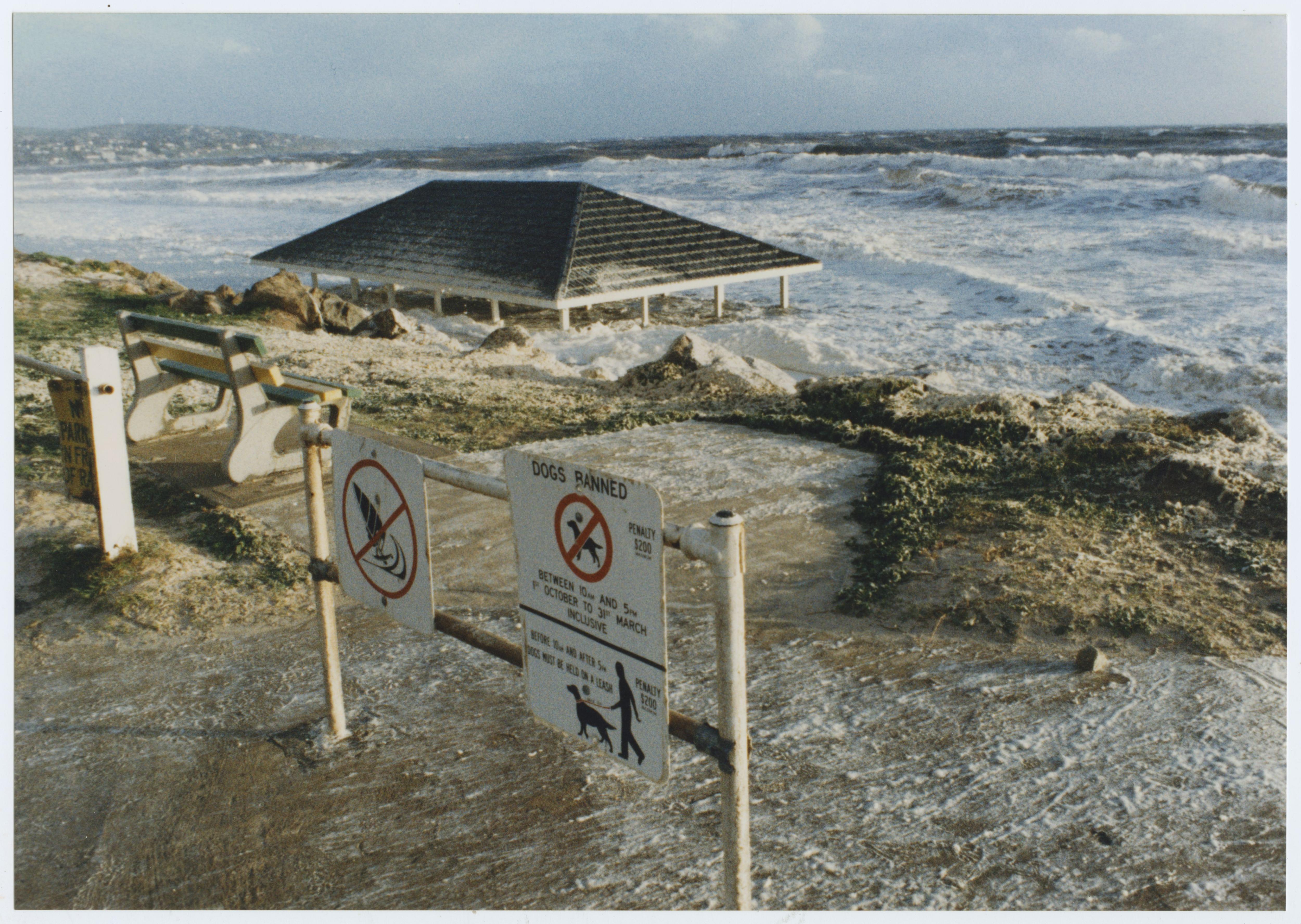 A beach shelter is almost submerged at high tide.