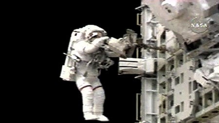 Spacewalker Sellers puts away tools during the second Discovery spacewalk.