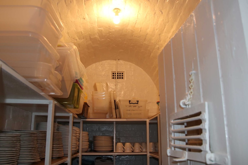 Convict cell, with kitchen items stored in it.