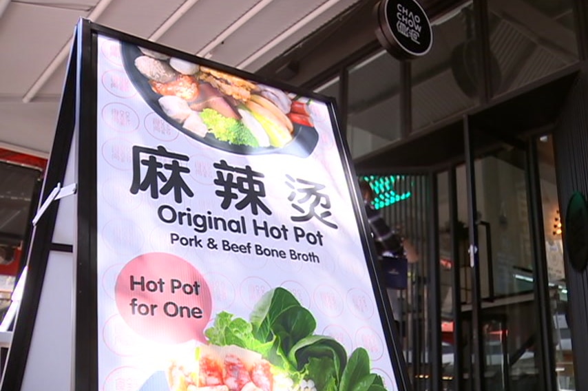 An A-frame sign promoting hot pot