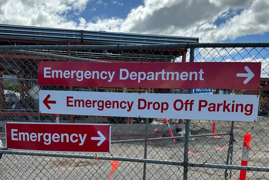 Signs that say emergency on a fence