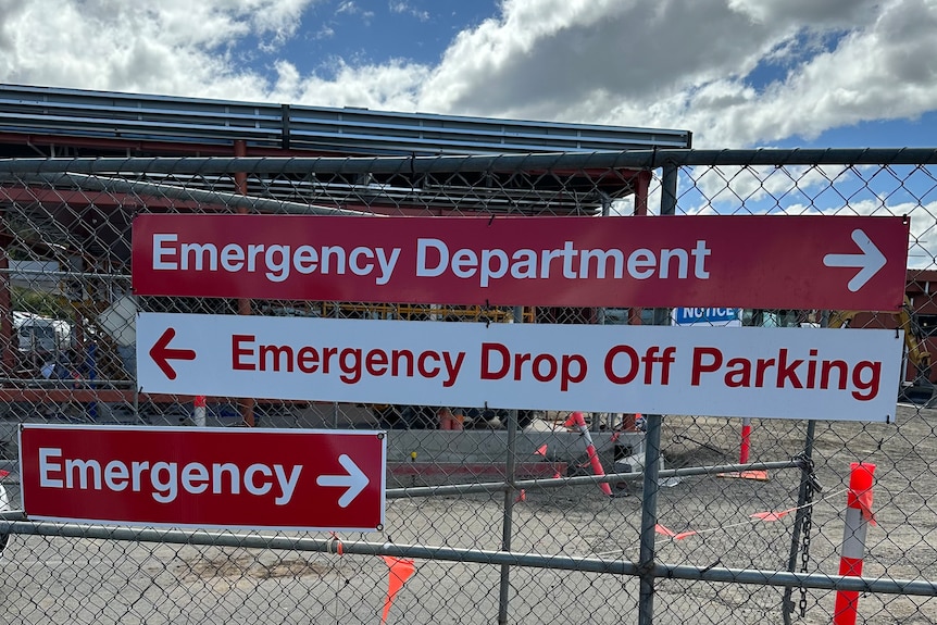 Signs that say emergency on a fence