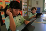 Mount Ousley Public School kindergarten pupils using an iPad in class