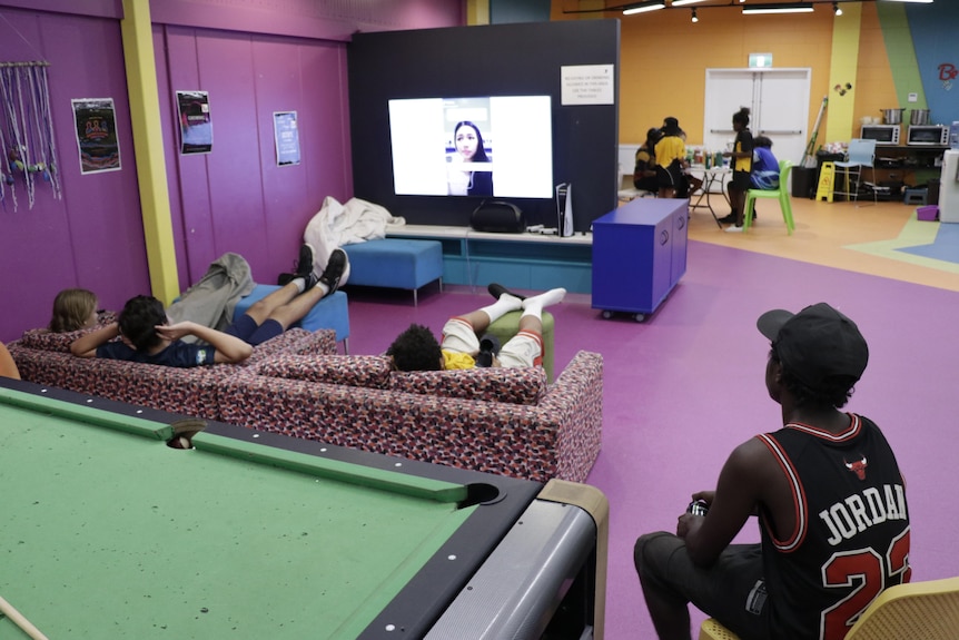 Young Palmerston residents watch TV in the new Youth Centre. 