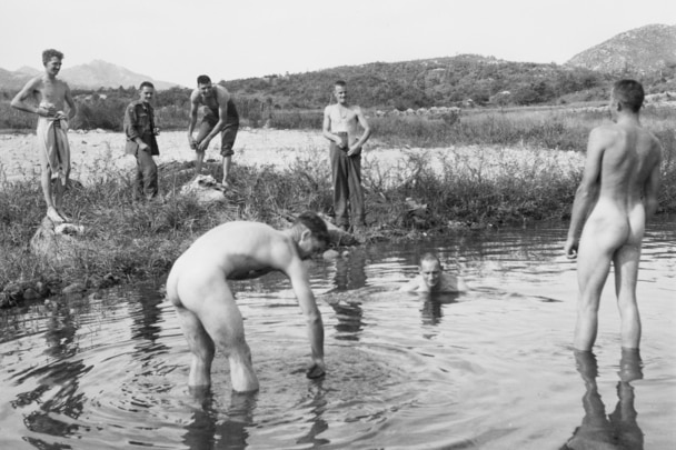 Australian troops wash in a river before they advance into North Korea