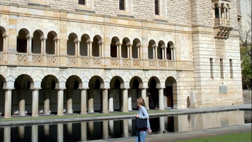 A student at the University of Western Australia walks past Winthrop Hall