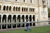 A student at the University of Western Australia walks past Winthrop Hall