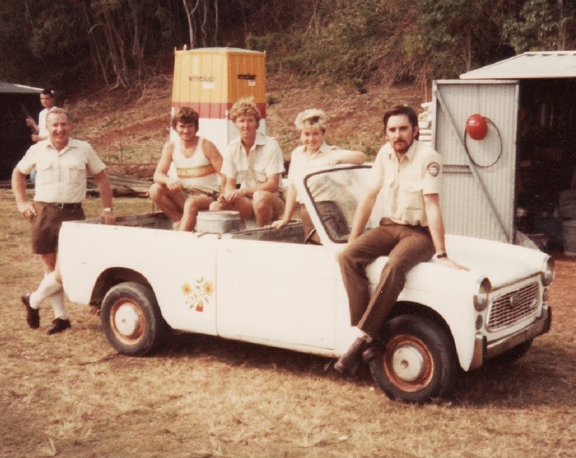 Five park rangers pose with a small ute in Queensland in the 1980s.