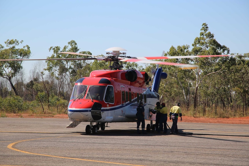 Members of the team refuel a helicopter at Djarindjin Airport.