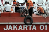 Asylum seekers sit on board an Indonesian rescue boat at Merak seaport in Java.