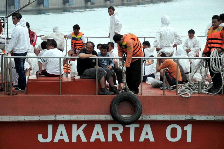 Asylum seekers sit on board an Indonesian rescue boat at Merak seaport in Java.