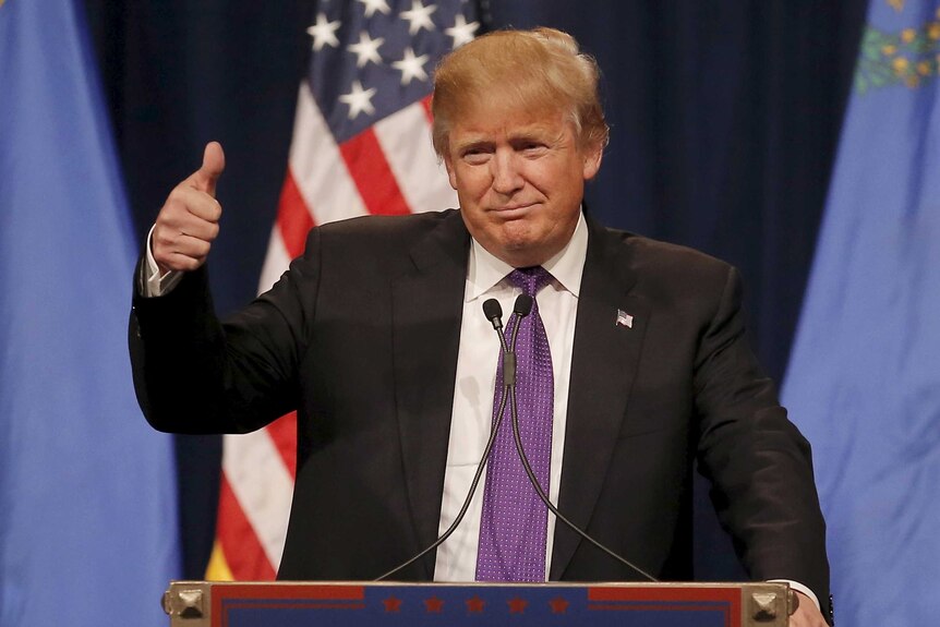 Republican US presidential candidate Donald Trump gives a thumbs up as he addresses supporters.