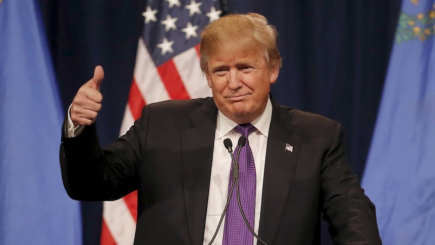 Republican US presidential candidate Donald Trump gives a thumbs up as he addresses supporters.