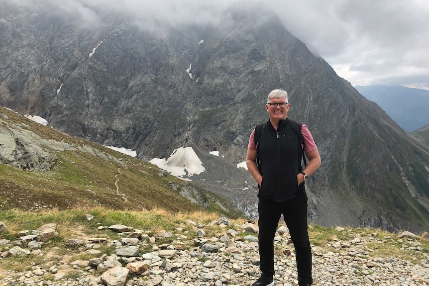 Merv Keane stands in front of the French Alps.