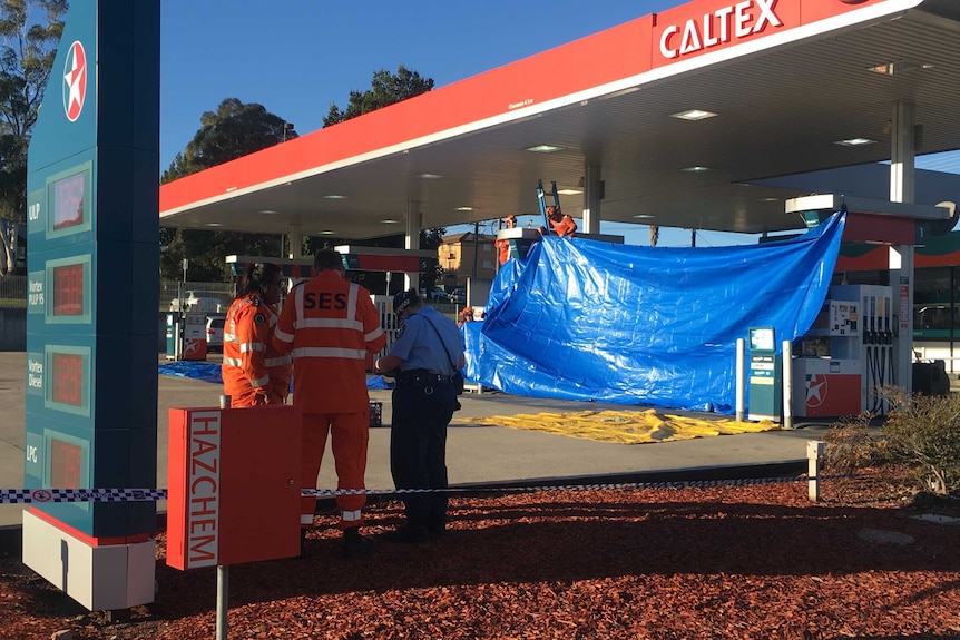 A cordon is set up at a service station in Queanbeyan where a fatal stabbing occurred
