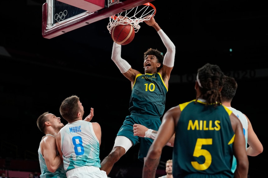Matisse Thybulle dunks the basketball in the bronze medal game between Australia and Slovenia at the Tokyo Olympics.