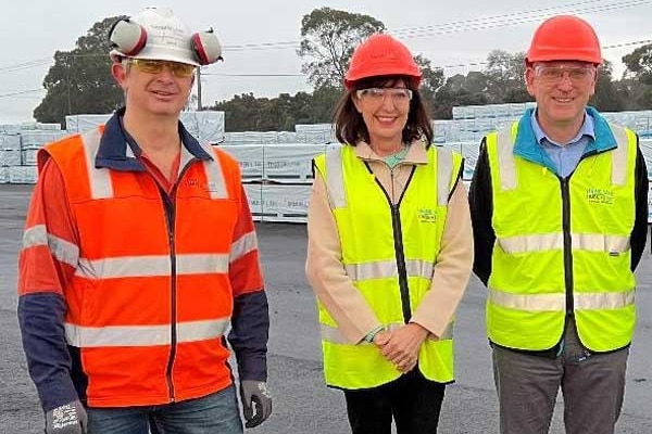 Two men, one woman in high vis, hard hats