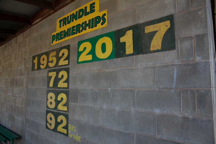 A concrete brick dressing shed with the words Trundle Premierships with year dates written below