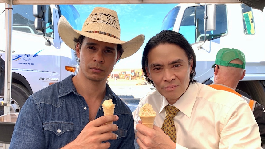 A close of two men holding icecreams