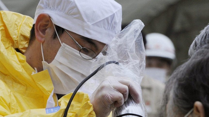 A baby is scanned for radiation in Nihonmatsu