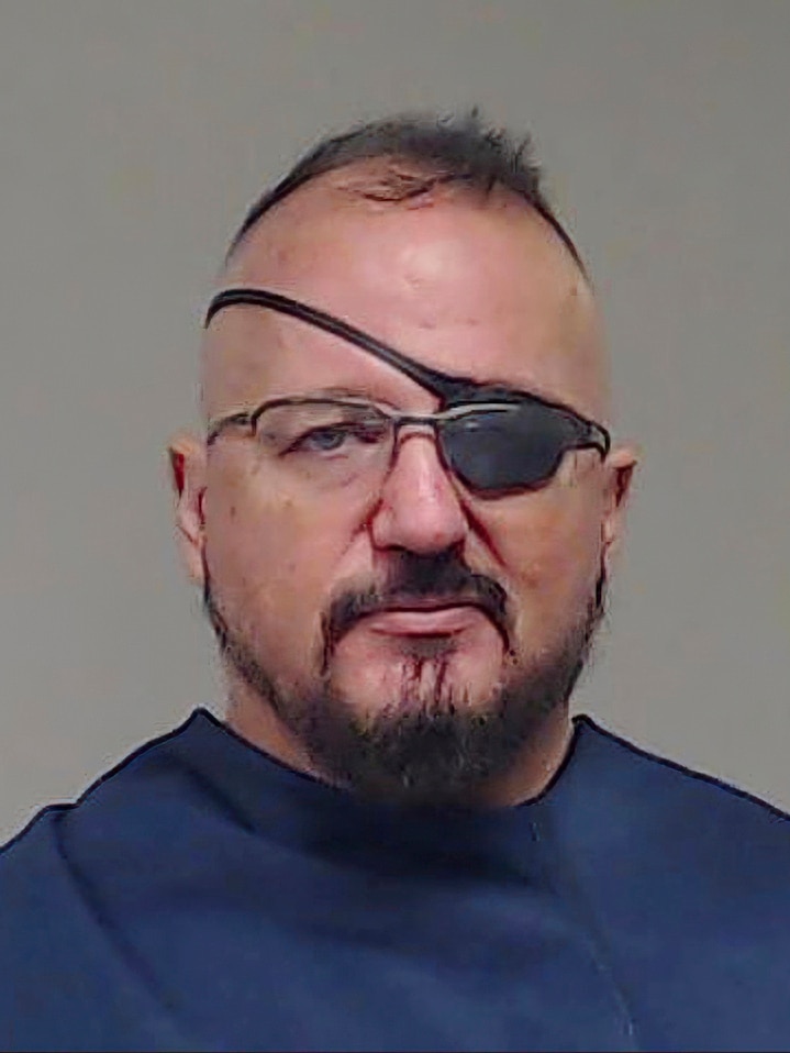 Stewart Rhodes wears an eye patch in a mug shot.