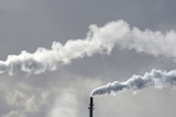 Smoke stacks with billowing clouds of smoke.