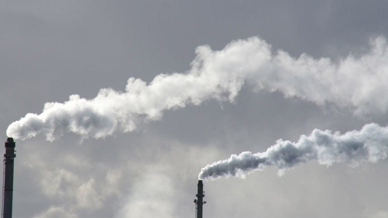 Smoke stacks with billowing clouds of smoke.