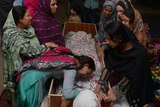Pakistani relatives mourn over the body of a victim during a funeral following a suicide bombing in Lahore.