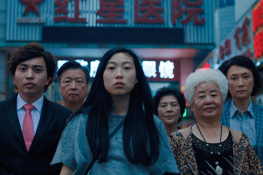 A still from the film The Farewell showing a family standing and looking at the camera. 
