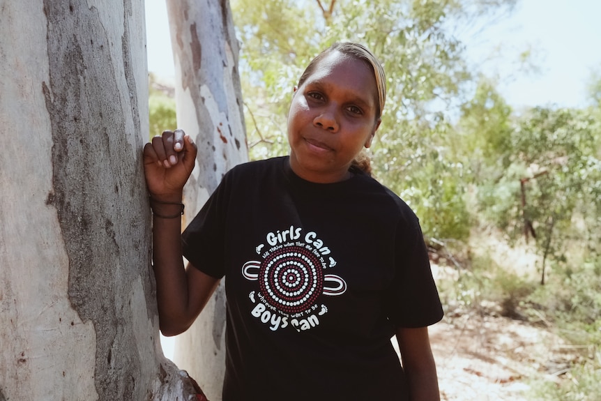 Sarah Rubuntja leaning on a tree