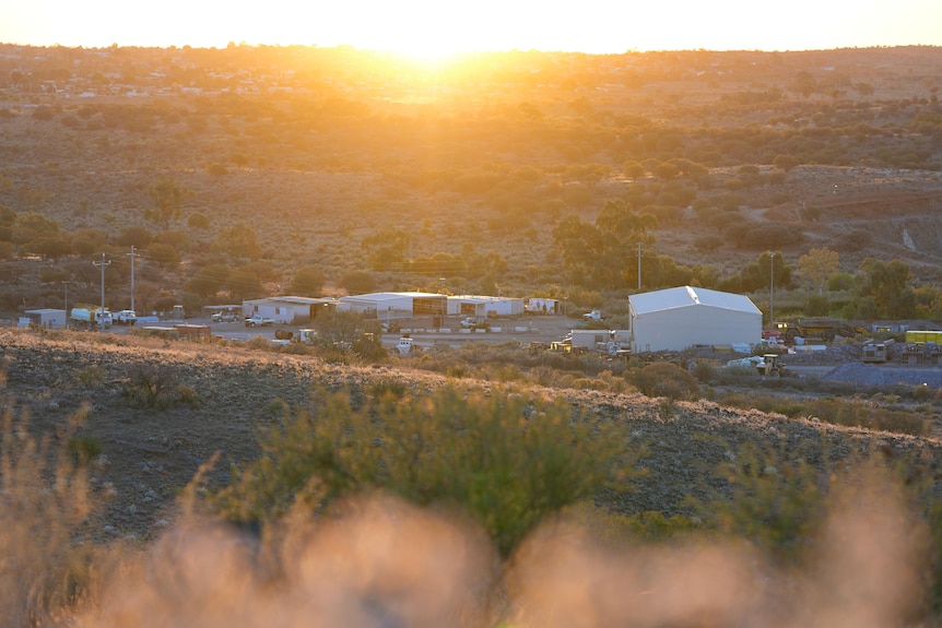 The sun sets over an outback mine site.