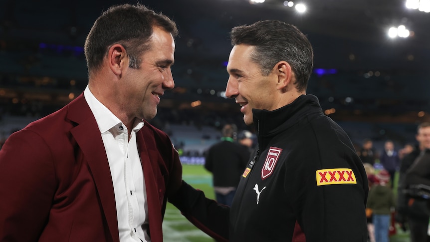 Two men celebrate winning a rugby league match 