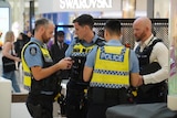 Four police officers in Westfield Carousel