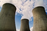 Steam rises from the stacks of a nuclear power plant