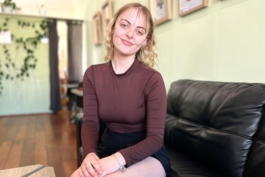 a woman sits on a couch