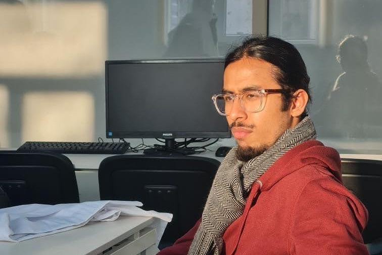 A man sitting with glasses. 