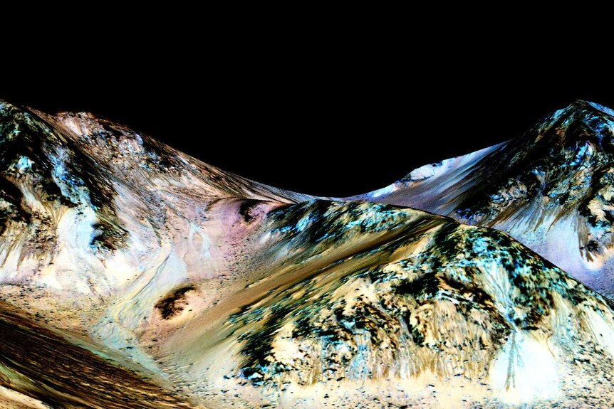 Dark, narrow, 100-metre-long streaks flowing downhill on Mars believed to have been formed by flowing water